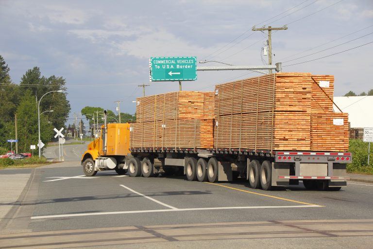 truck loaded with piles of wood