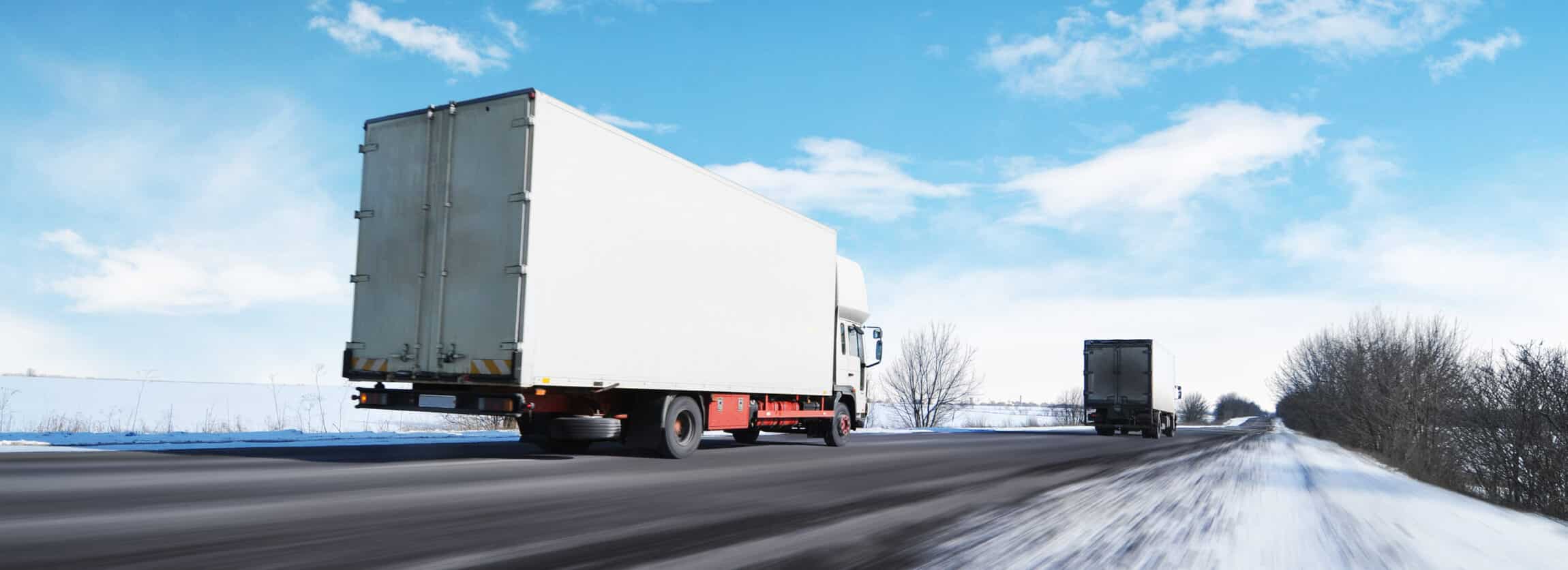 Two white box trucks