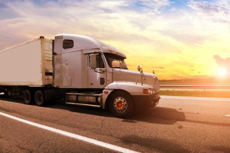 Close-up of a truck against a sunset