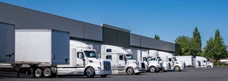 semi trailers standing in a row at warehouse