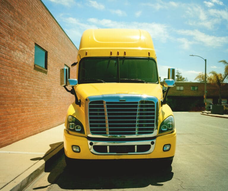 Big Yellow Truck Parked in Alley