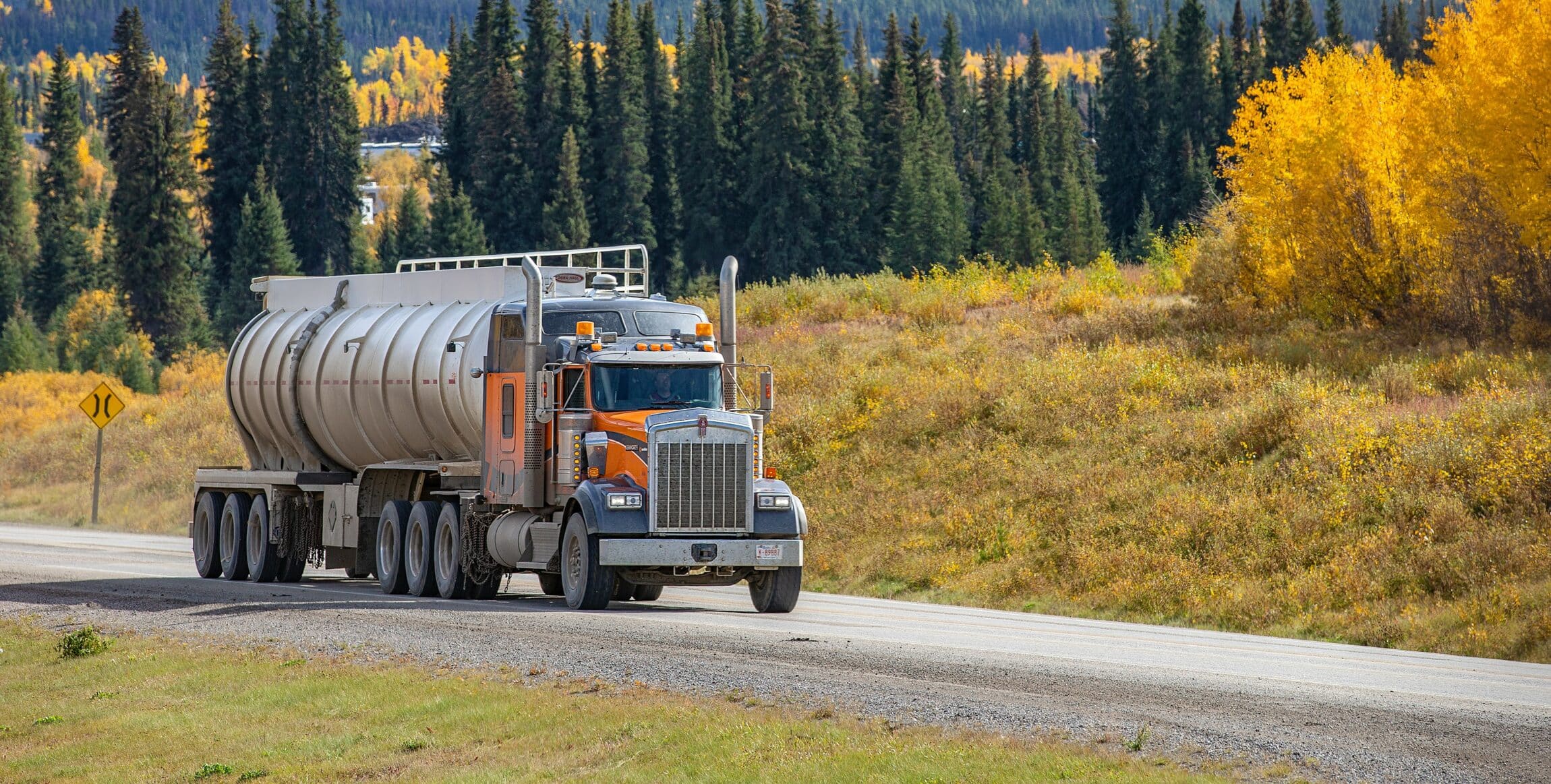 Semi truck with trailer driving on highway