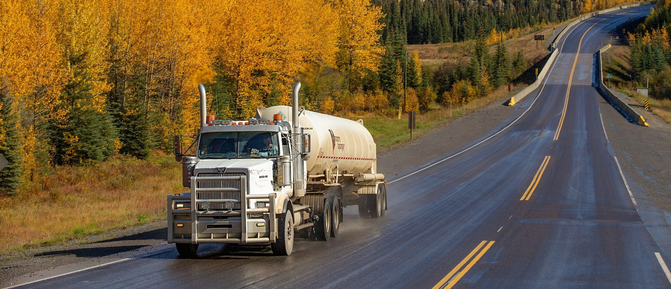 Semi truck with trailer driving on highway