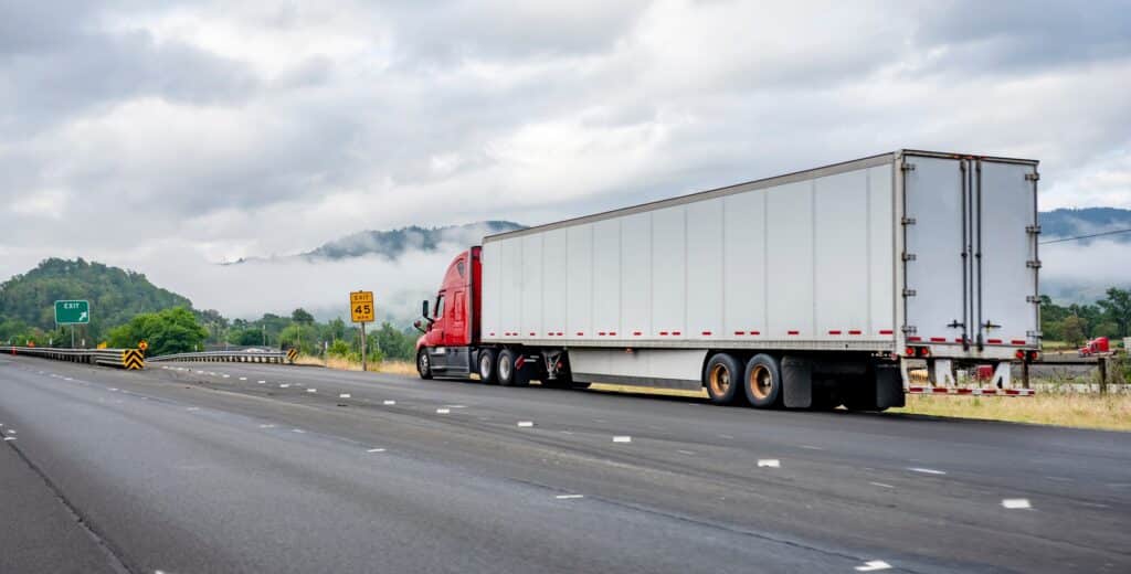 Bright red industrial long haul big rig semi truck