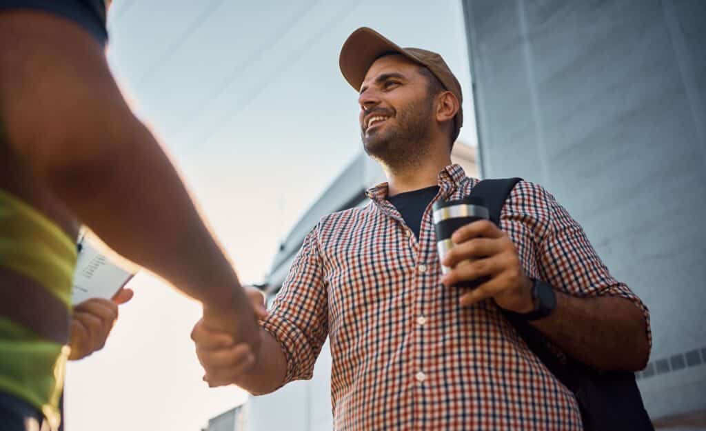 happy truck driver shakes hands