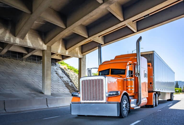 Orange rig under bridge