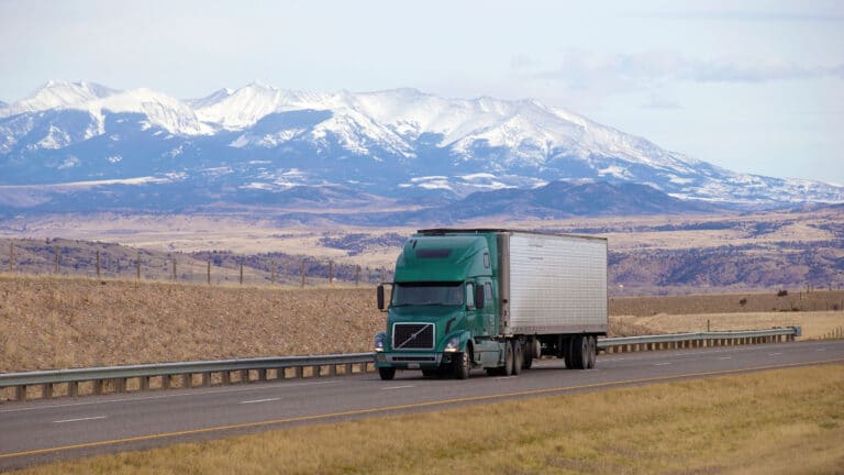 Trailer on road with mountain in the background