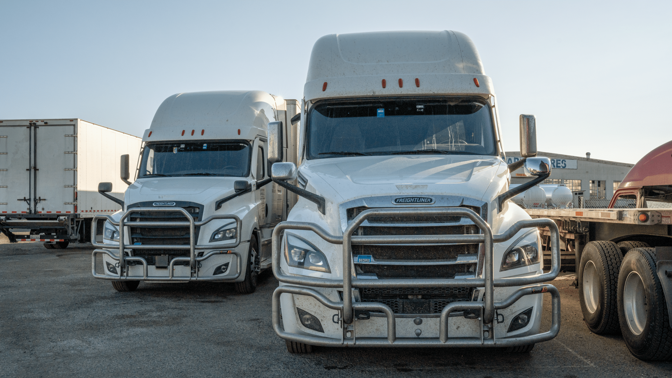 Front of two white semis