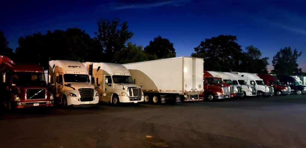 Big rigs in parking lot at night