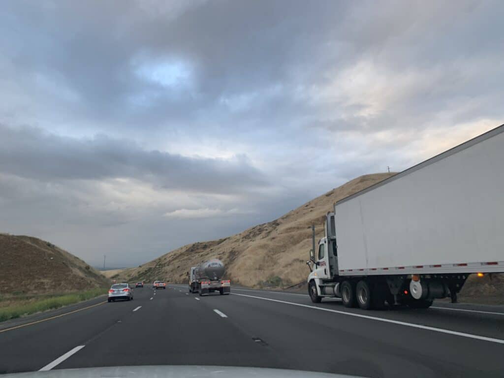 Truck on road with a cloudy sky