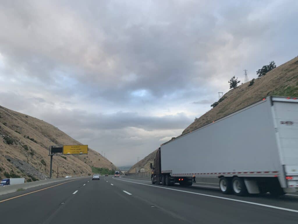 big rig on road with cloudy sky