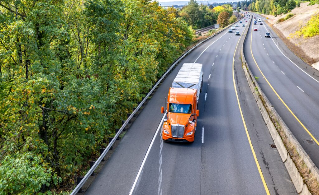 orange semi truck on the road