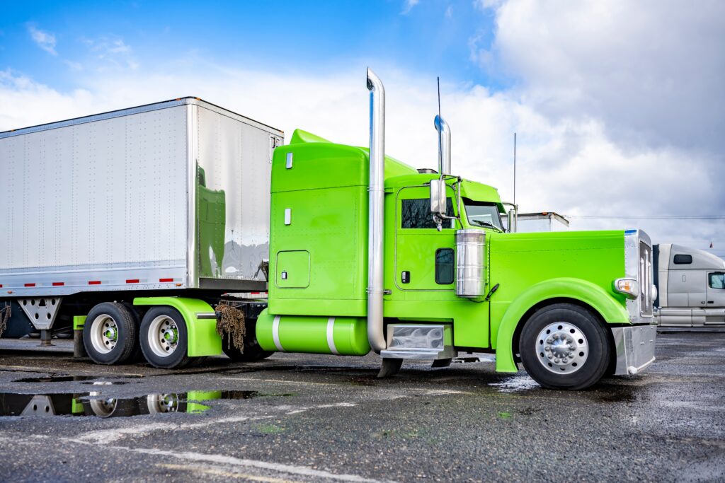 green big rig on the parking lot