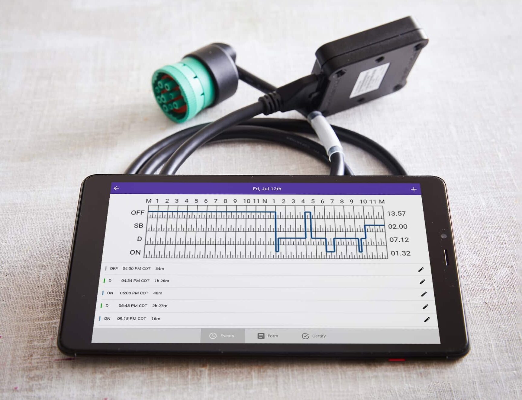 HOS247 ELD system with tablet displaying driver logs