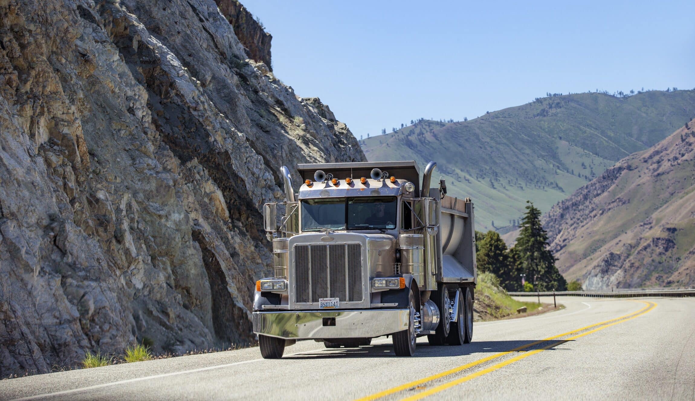 Semi truck with trailer driving on highway