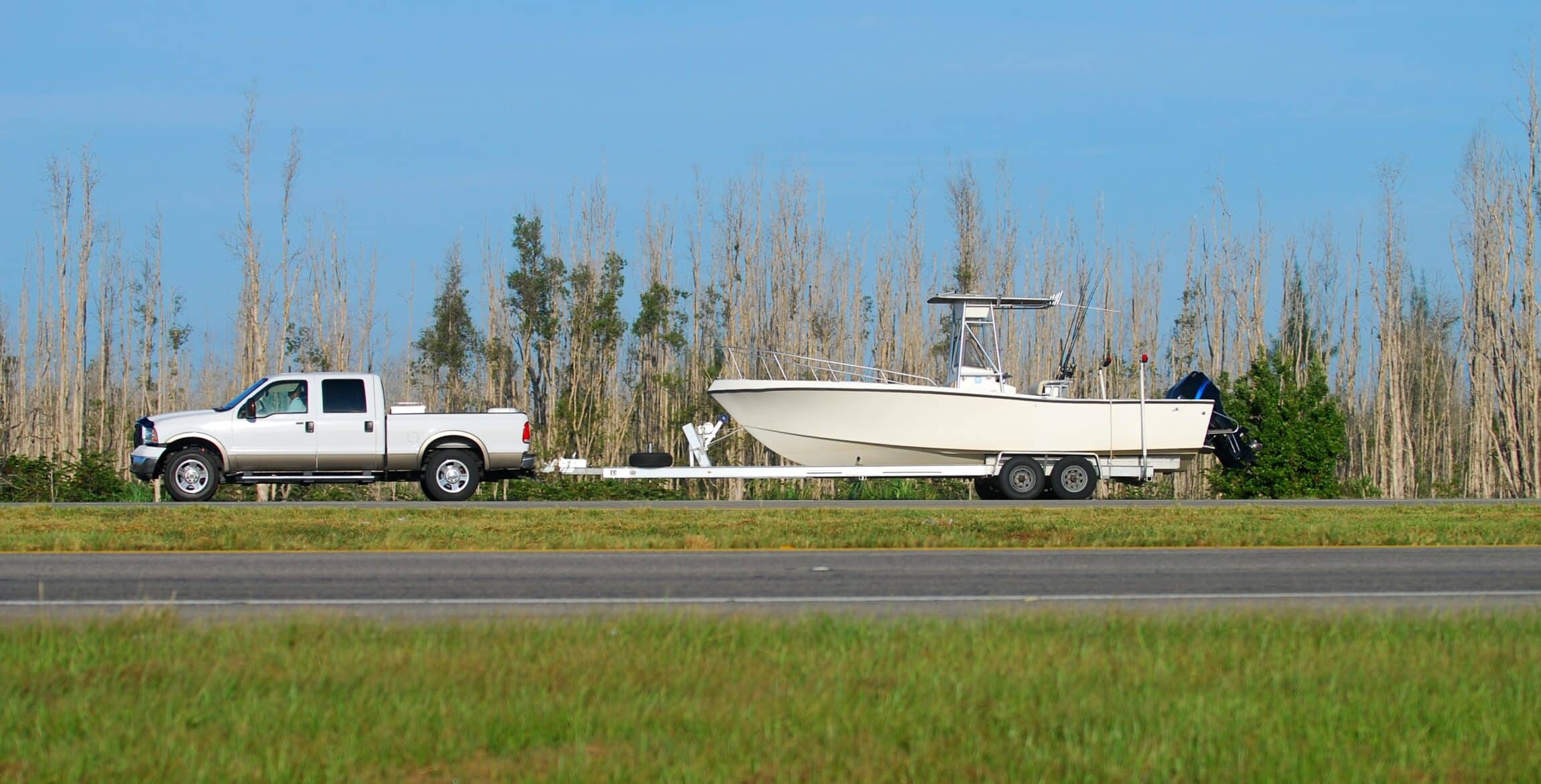 Pickup truck towing boat on trailer