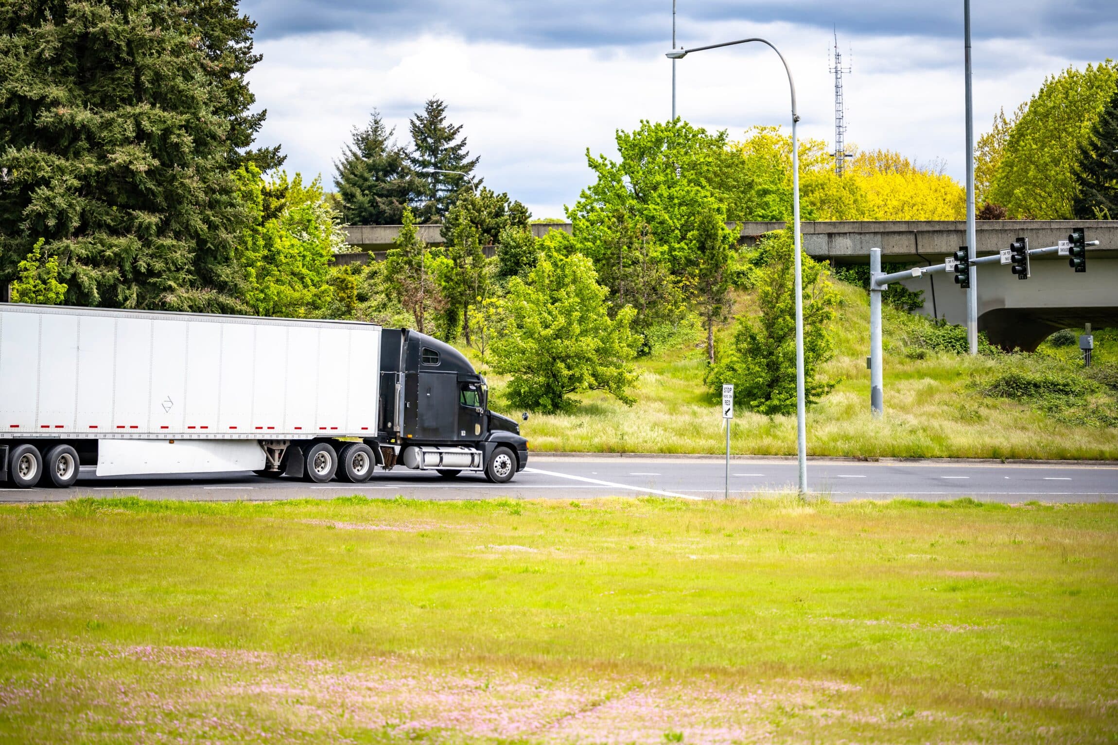 Loaded big rig black semi truck