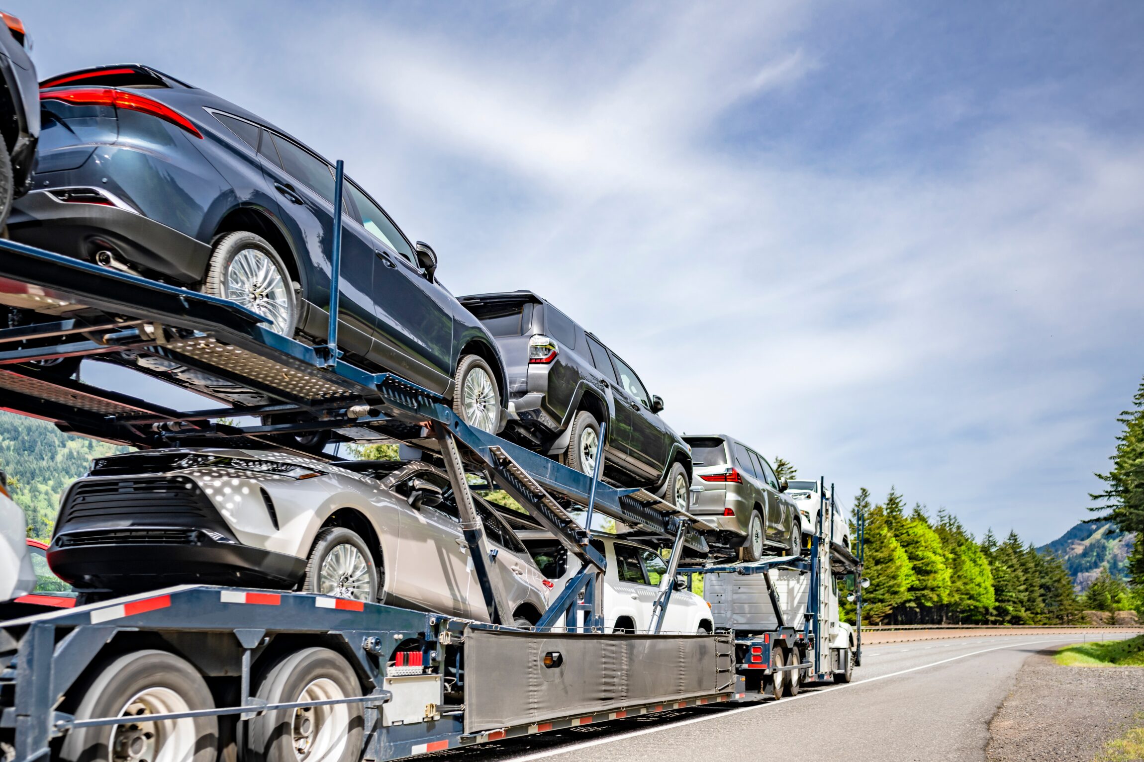 Industrial big rig car hauler semi truck tractor transporting fastened cars