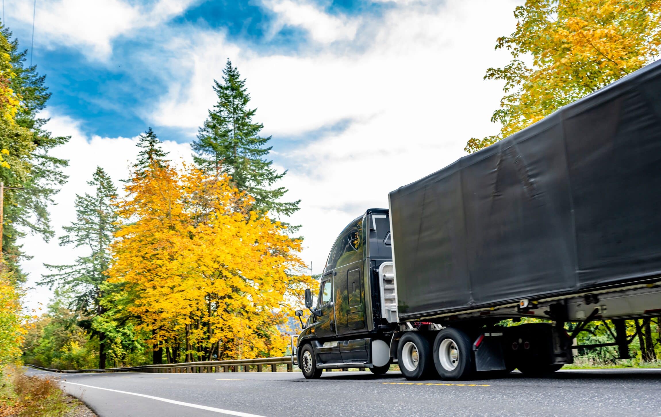 black big rig transporting commercial cargo