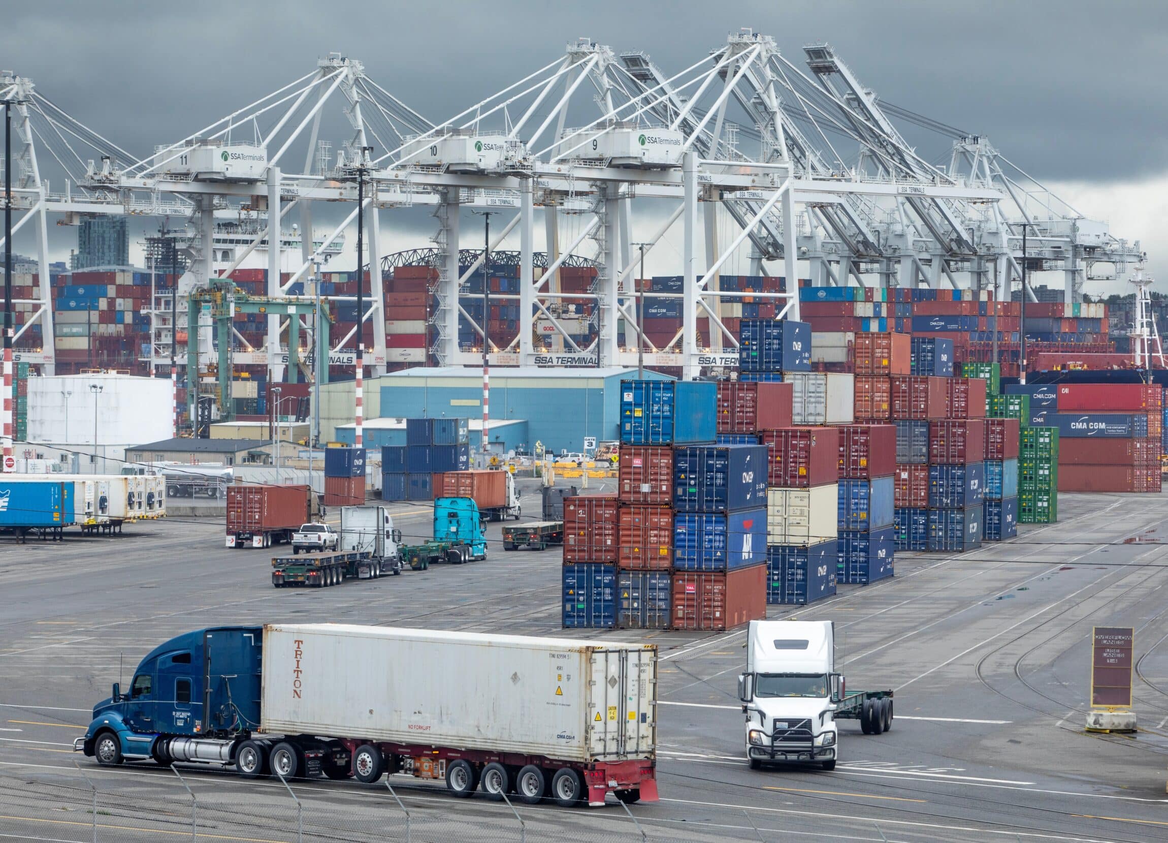 Tractor-trailers line up to receive containers