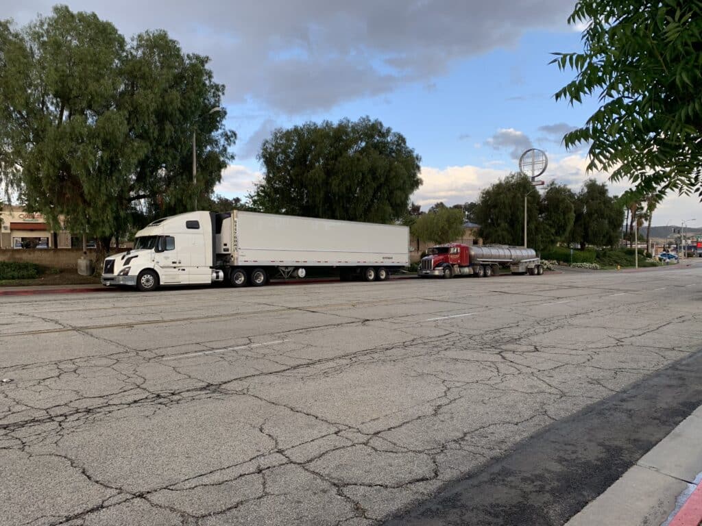 commercial semi truck parked at the side of the road