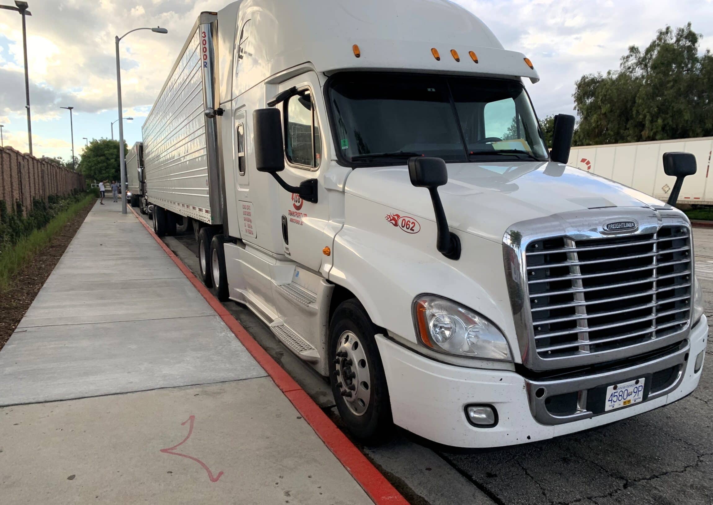 white freight liner on a parking lot