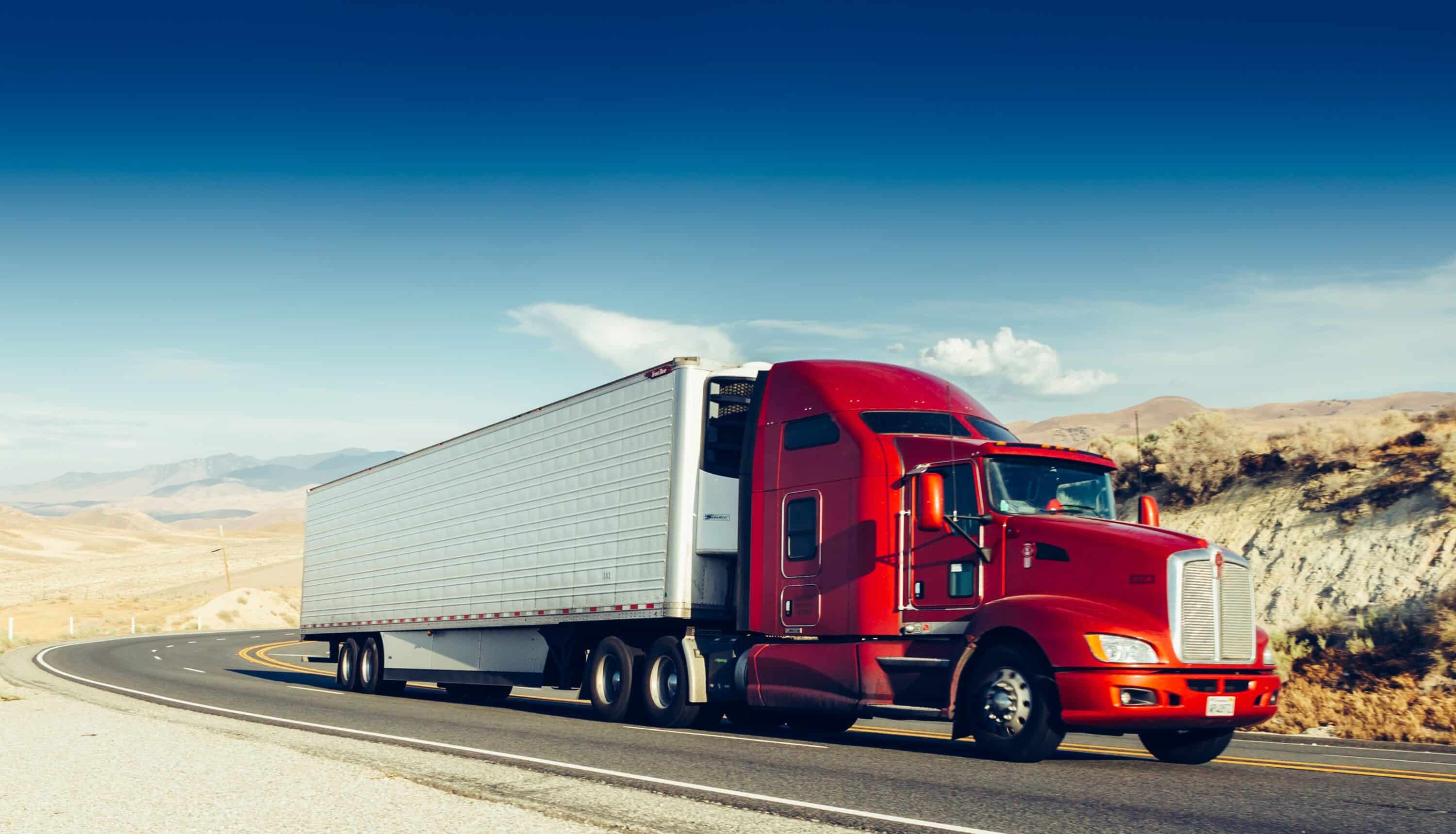 Red cabin truck on the road