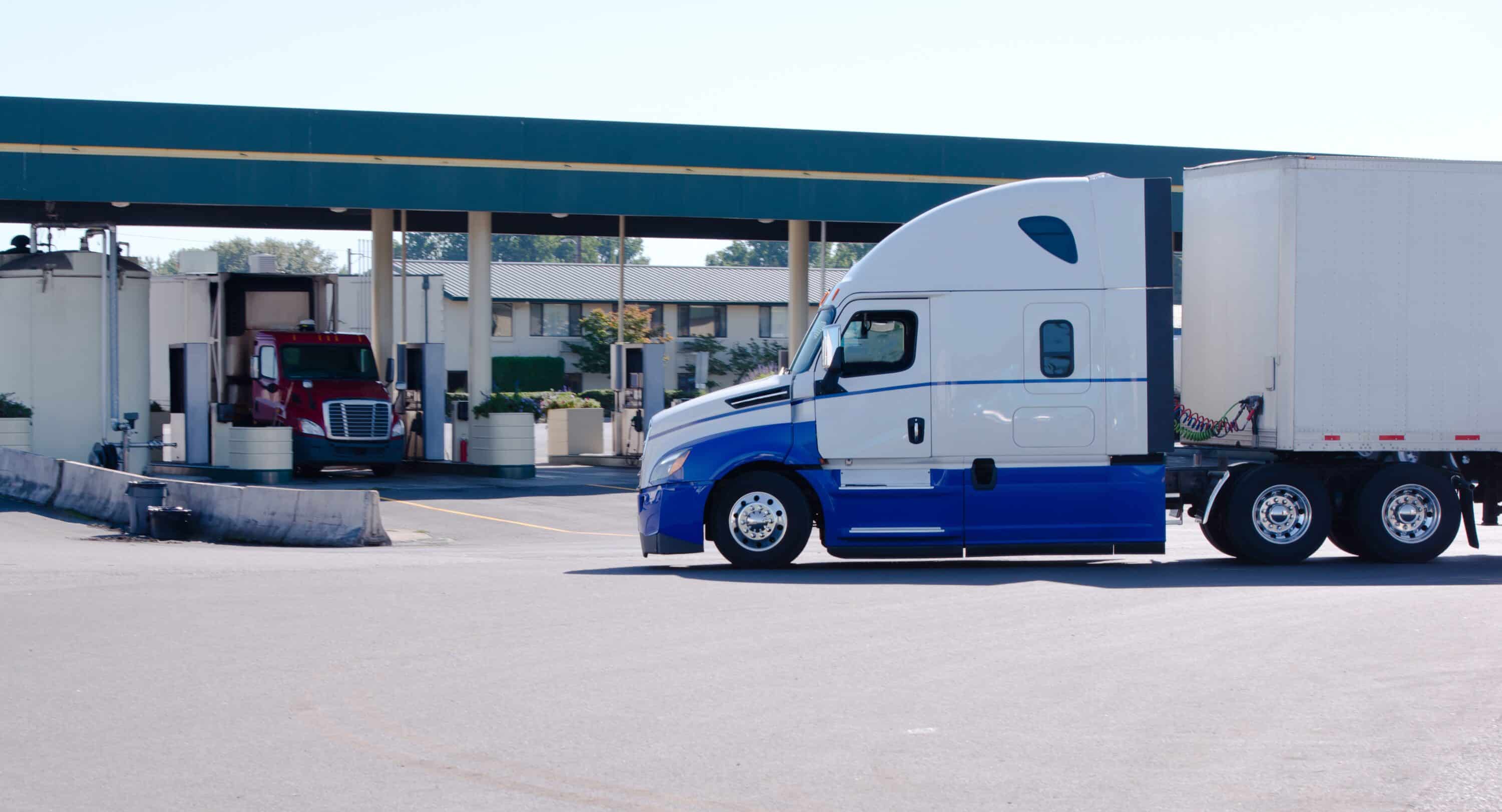 Long haul big rig semi truck on truck stop to gas station