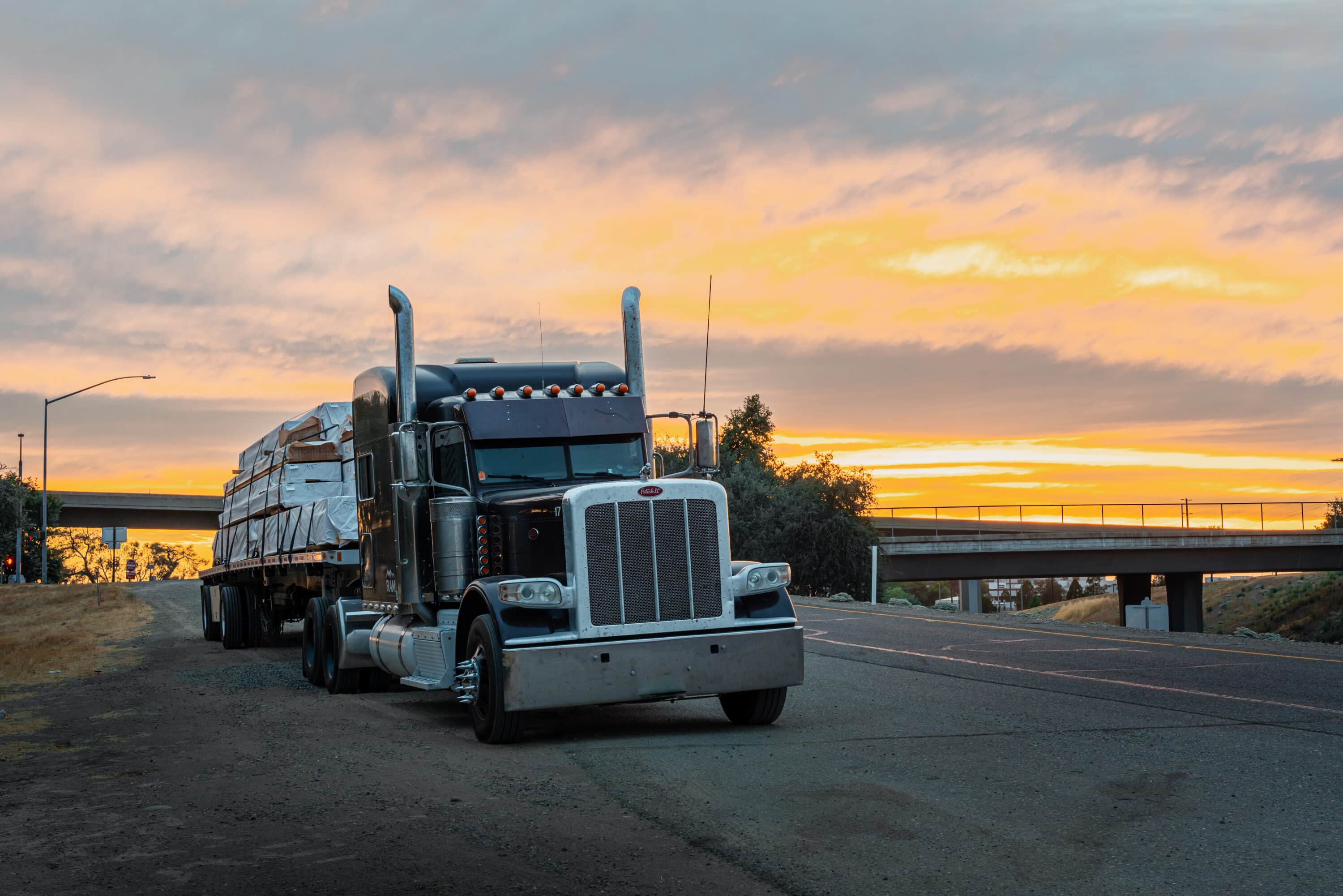 heavy loaded red truck on the highway