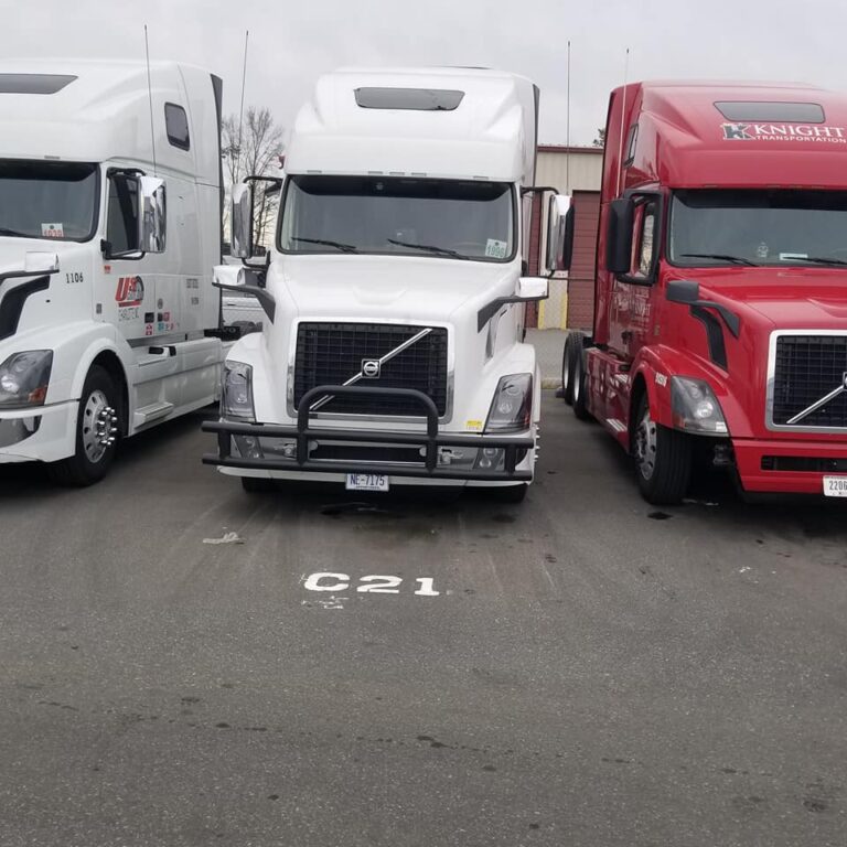 big rigs lined up in parking lot