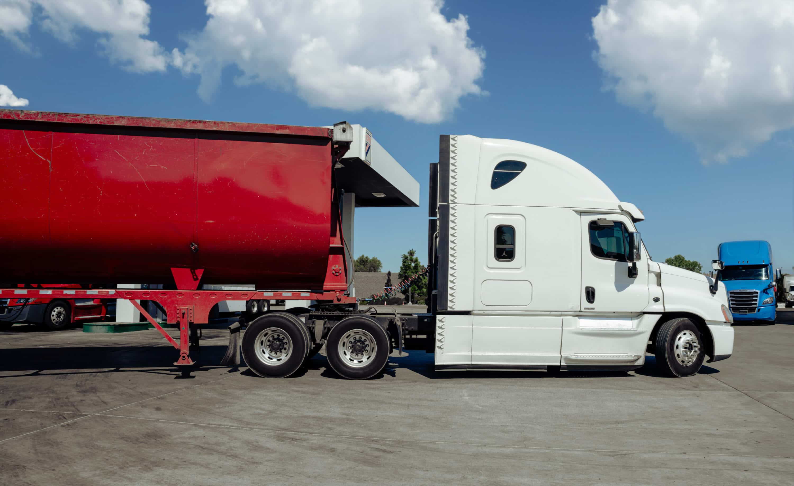white truck with a red trailer