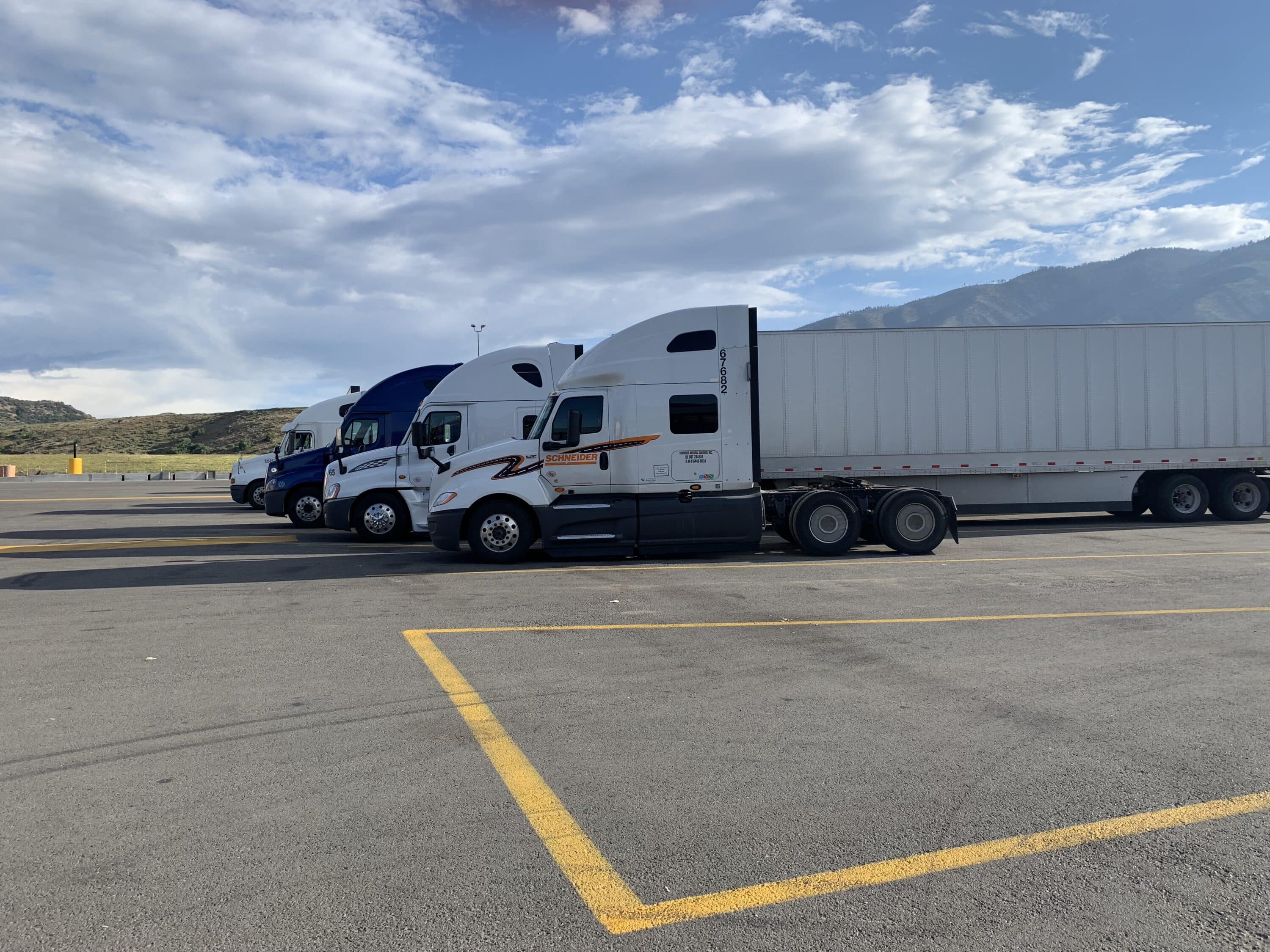 truck in parking lot and blue sky with clouds