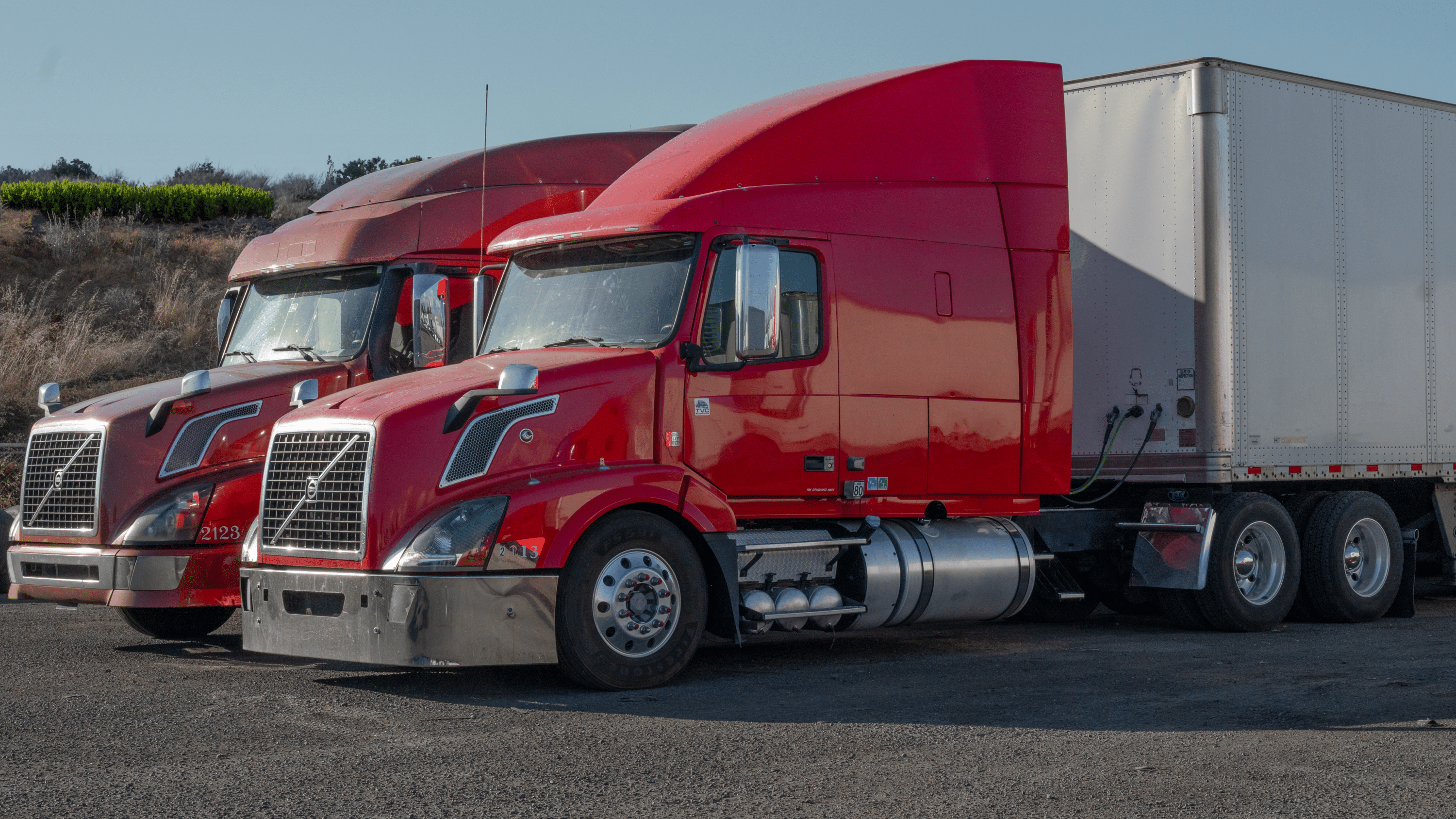 two red trucks on the parking lot