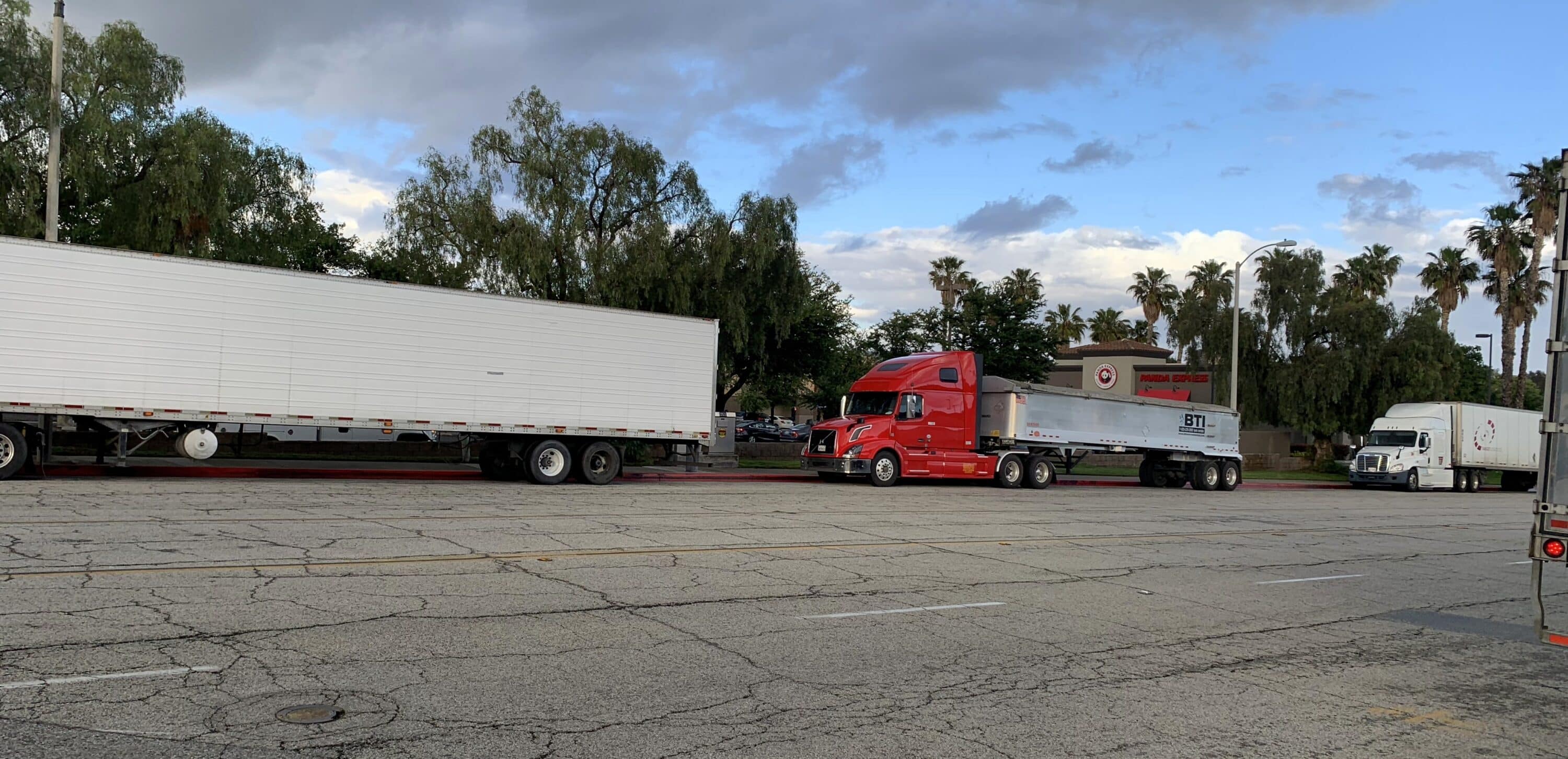 trucks standing on the side of the road