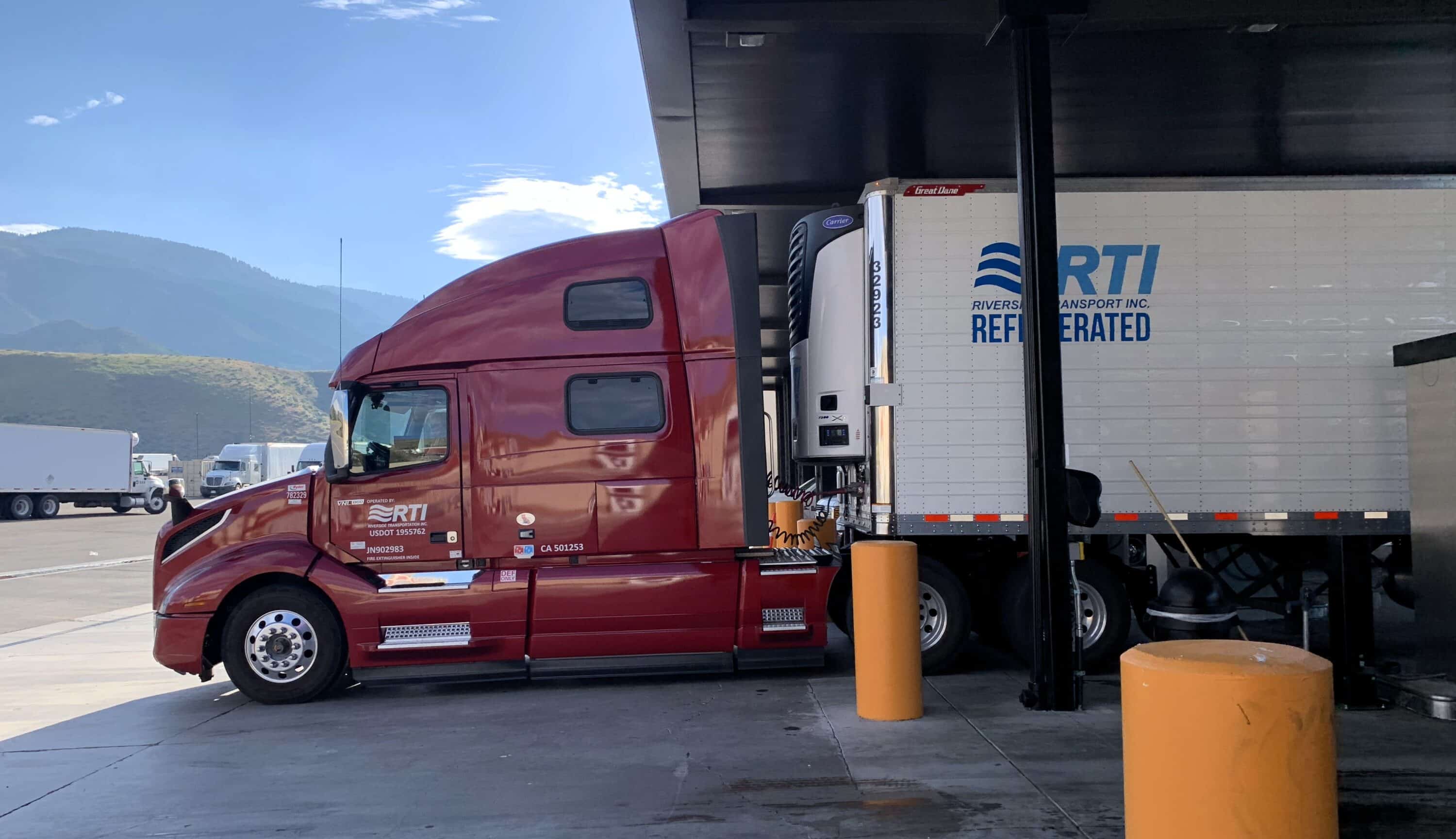 Red bonnet truck on gas station
