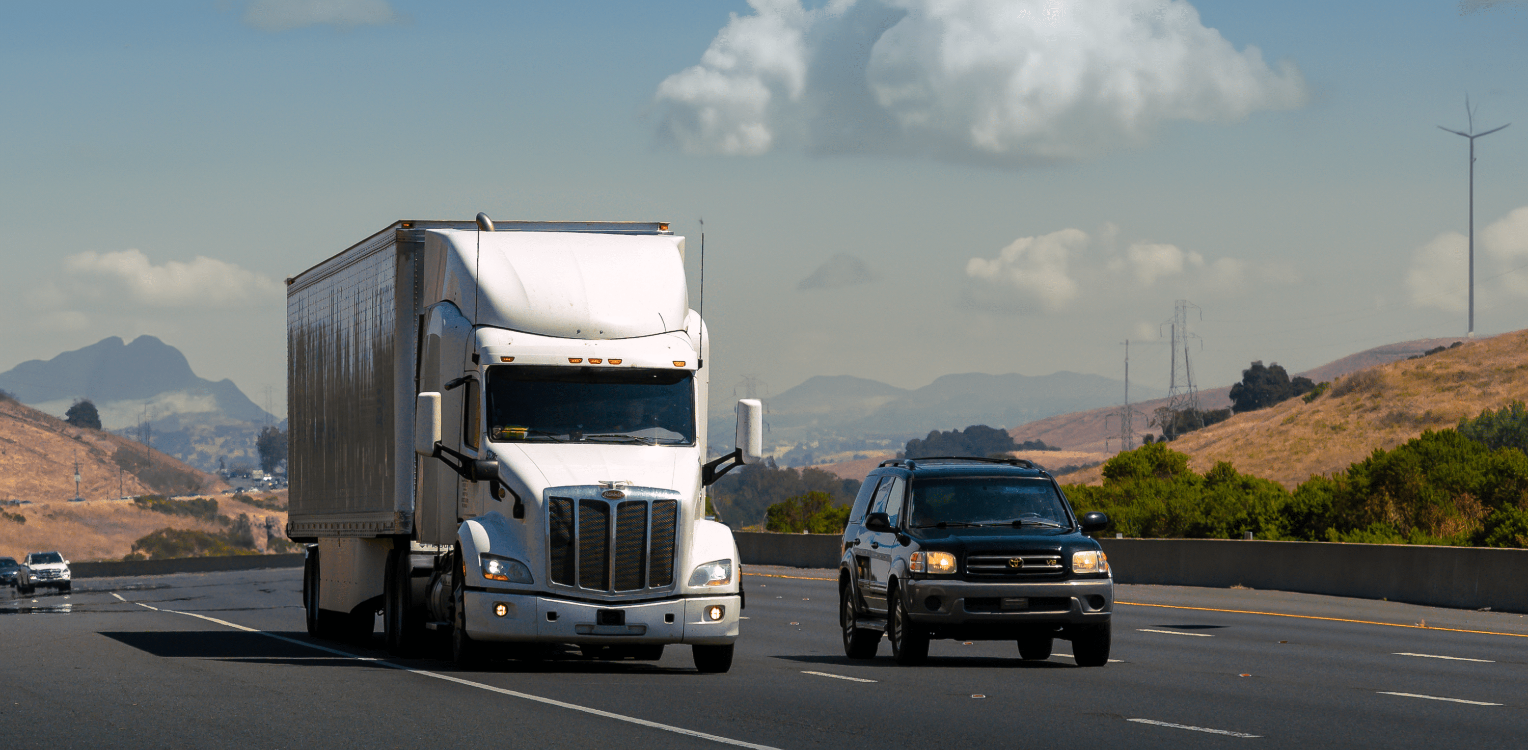 a white semi truck on the road
