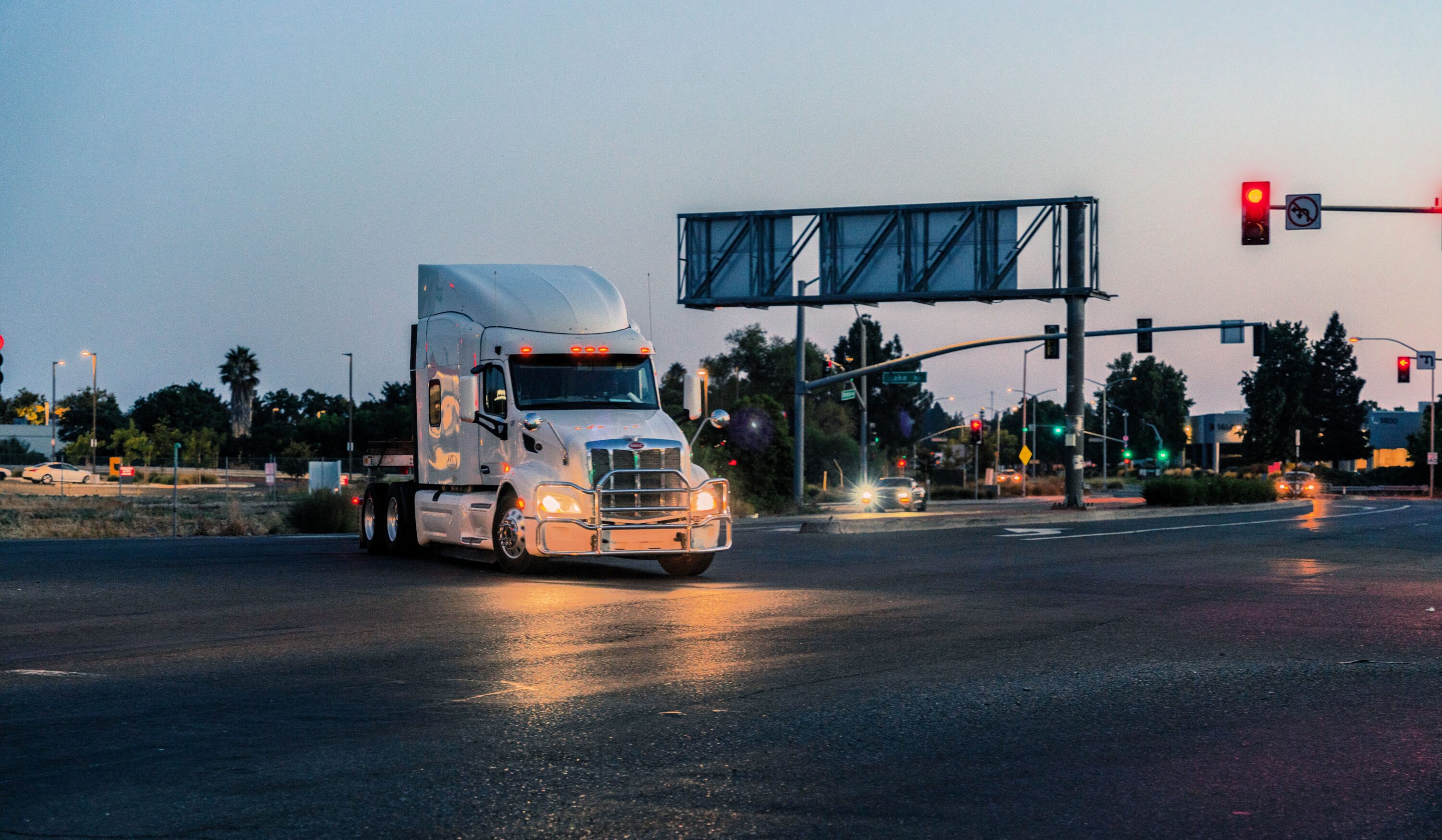 white semi truck tractor on the night road