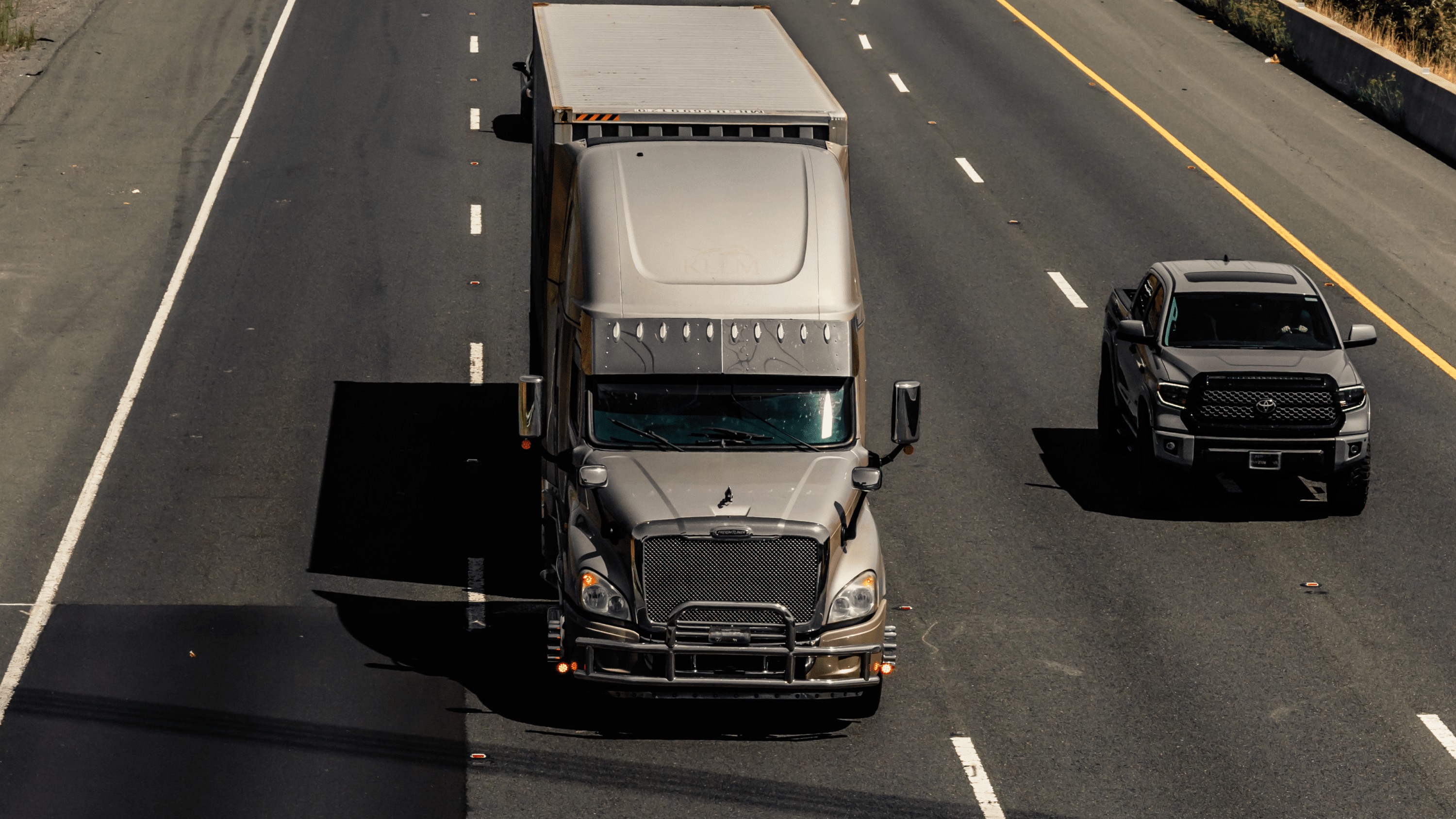 grey semi truck on the highway