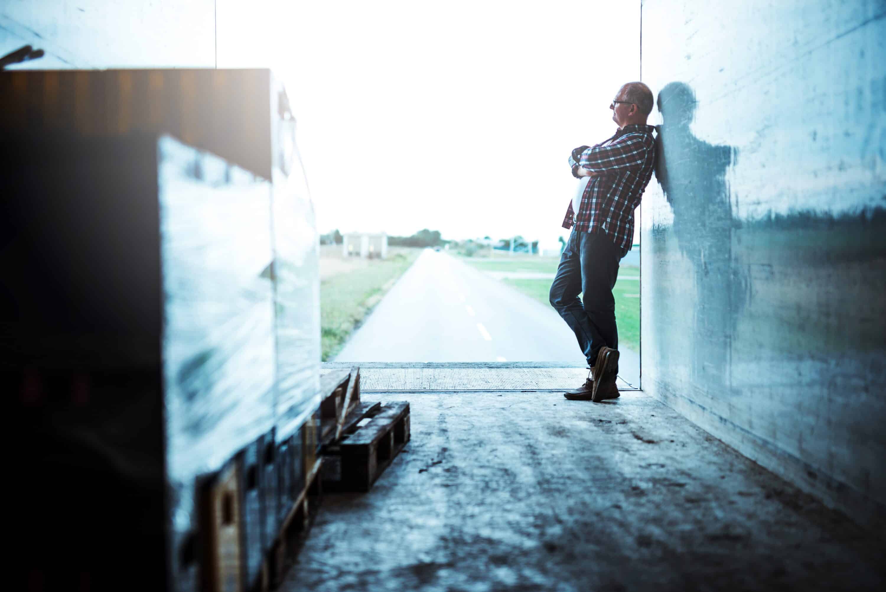 trucker standing inside of a trailer