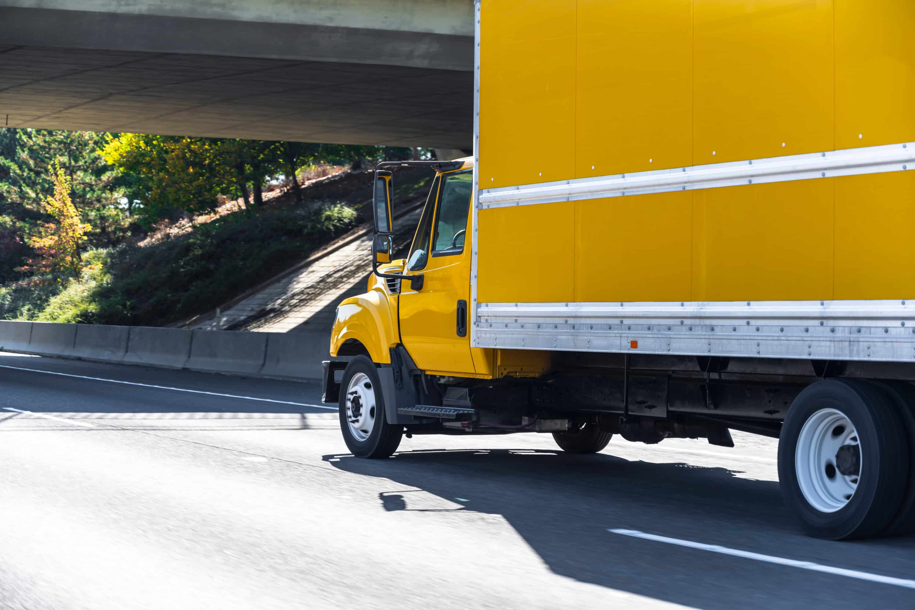 Yellow small size compact rig semi truck with box trailer