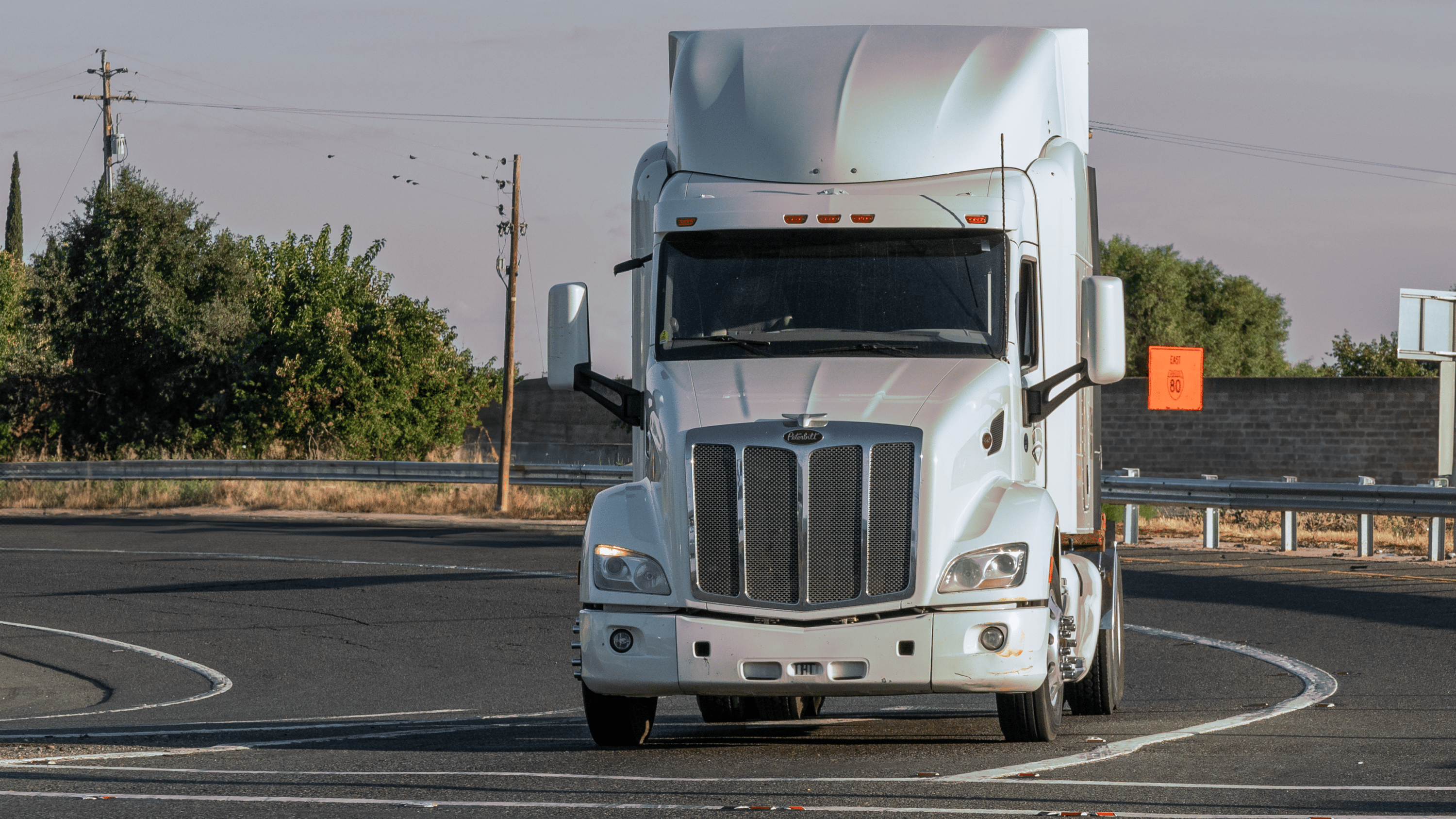 White bonnet semi truck on the road