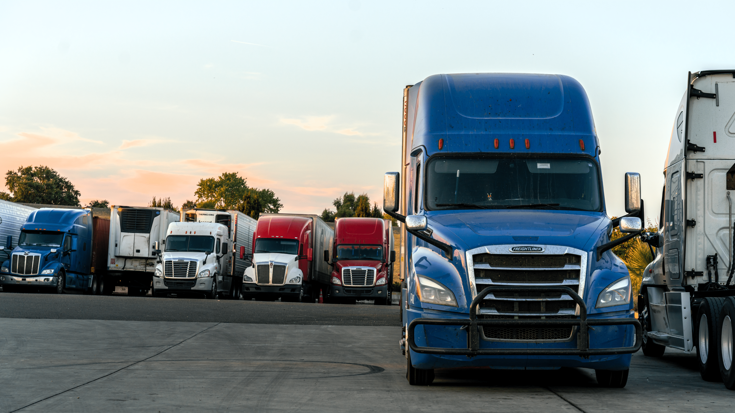 Commercial trucks parked at truck stop during required driver rest period