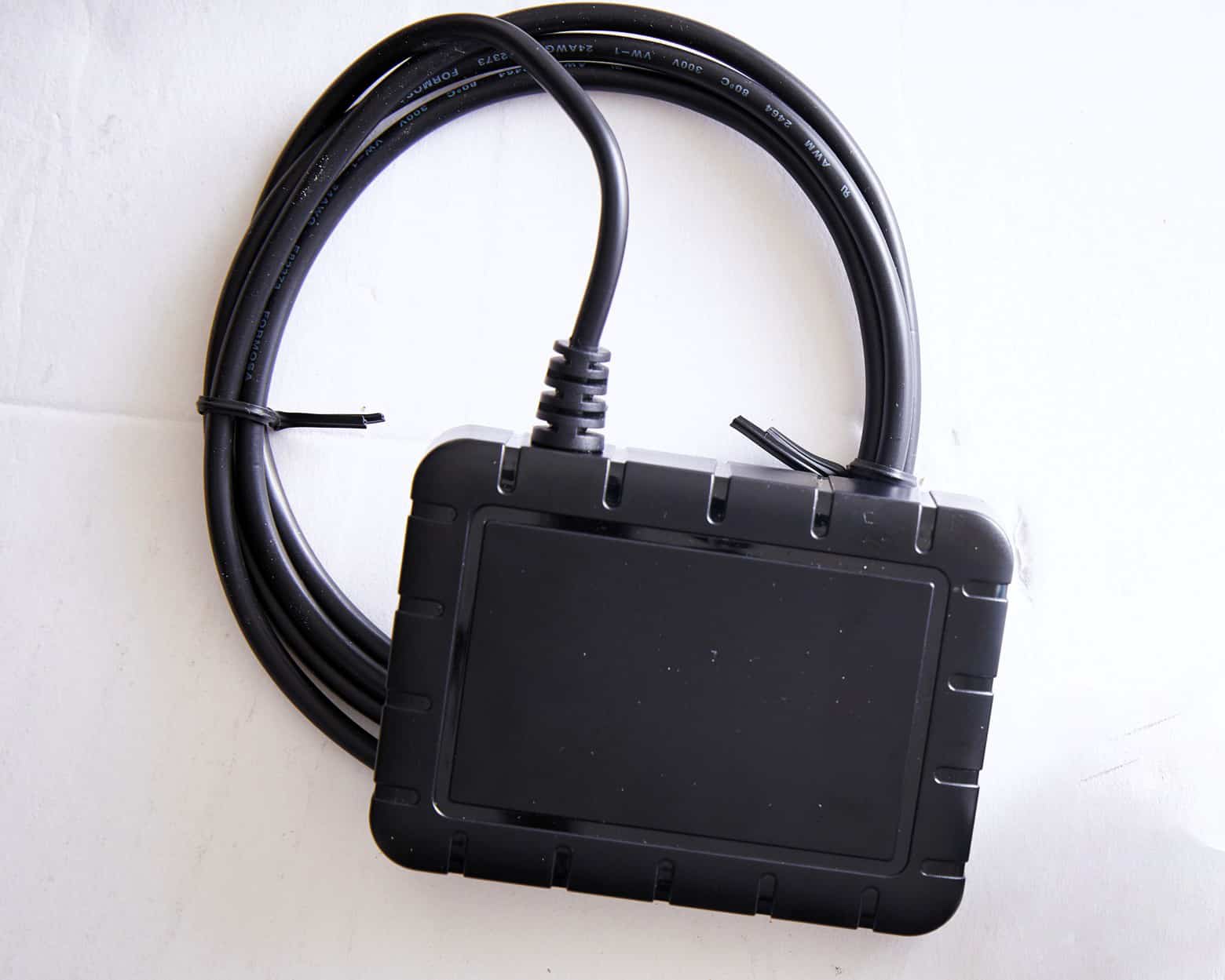HOS247 GPS tracking device with attached cable displayed on a white background